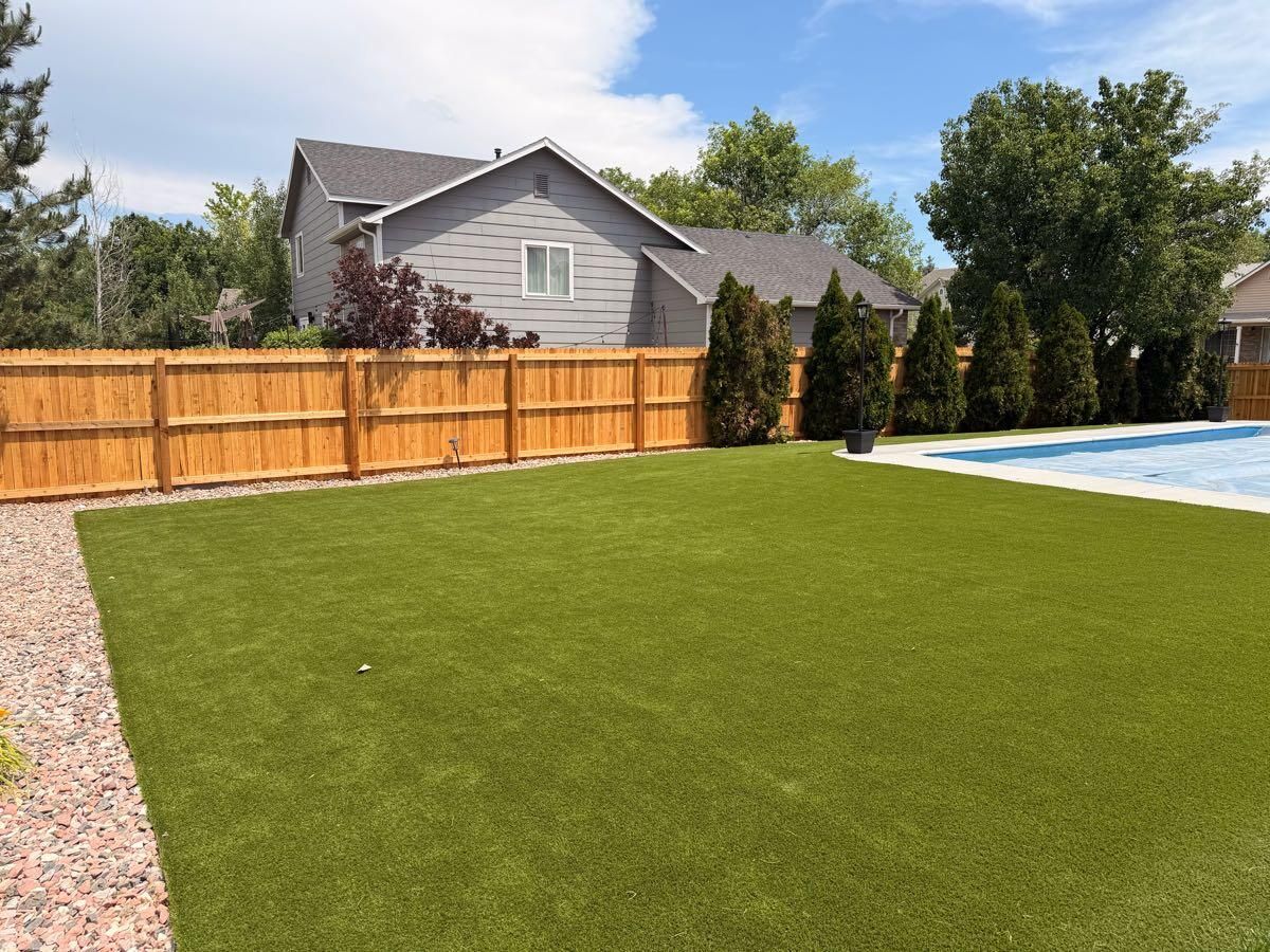 Cedar privacy fence around a backyard with turf and pool, built by Rocky Mountain Fencing